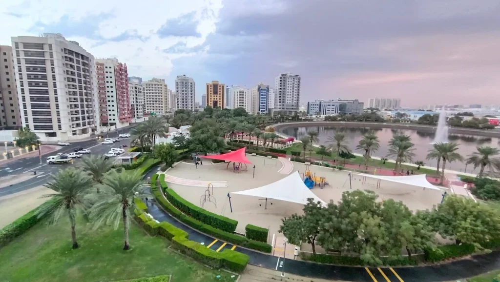 Al Nahda Pond Park Dubai scenic lake view with jogging track and green trees
