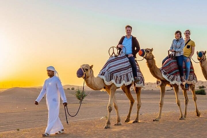 camel ride desert safari dubai sunset