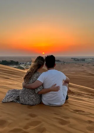 Couple watching sunset in desert