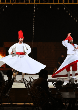 Traditional Tanoura dance performance at a Dubai desert safari camp