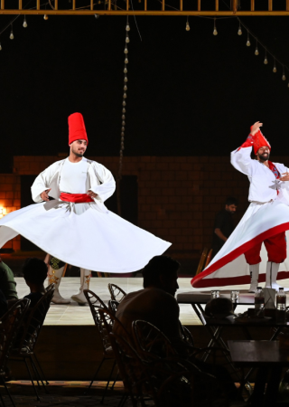 Traditional Tanoura dance performance at a Dubai desert safari camp