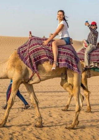 Traditional camel caravan ride across the Arabian desert in Dubai